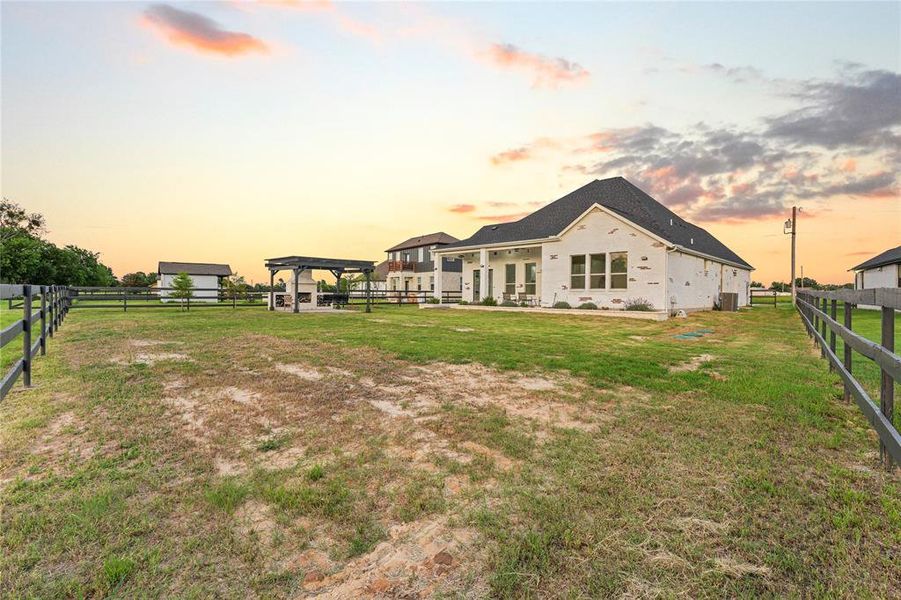 Back of house at dusk featuring a gazebo Back of house at dusk featuring a gazebo
