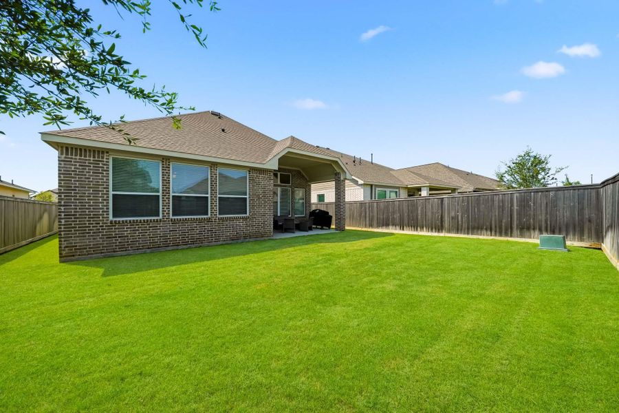 The backyard offers plenty of room for outdoor play, weekend adventures and memorable moments, creating a versatile setting for kids to run, explore and enjoy the outdoors.