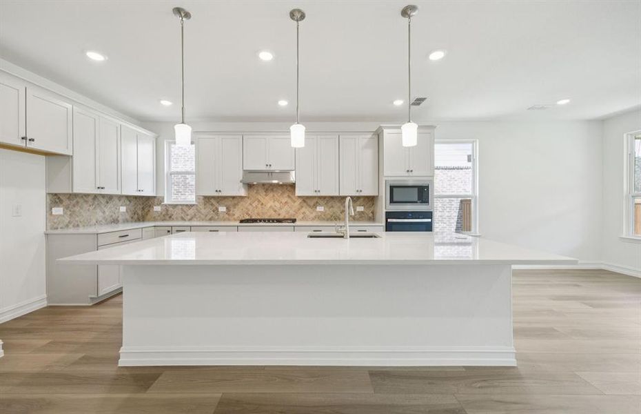 Bright kitchen with an expansive center island perfect for gatherings *Real home pictured Bright kitchen with an expansive center island perfect for gatherings *Real home pictured