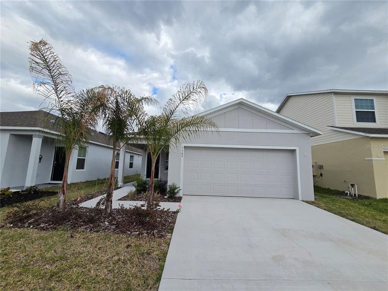 Front exterior of a new home in Hammock Reserve, Haines City, FL, highlighting curb appeal (Image 21). Front exterior of a new home in Hammock Reserve, Haines City, FL, highlighting curb appeal (Image 21).