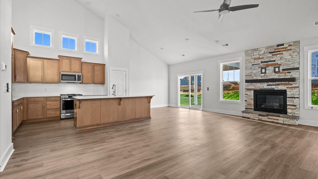 First-rate family room with fireplace, eye-catching two-story ceilings, and superior architectural detail