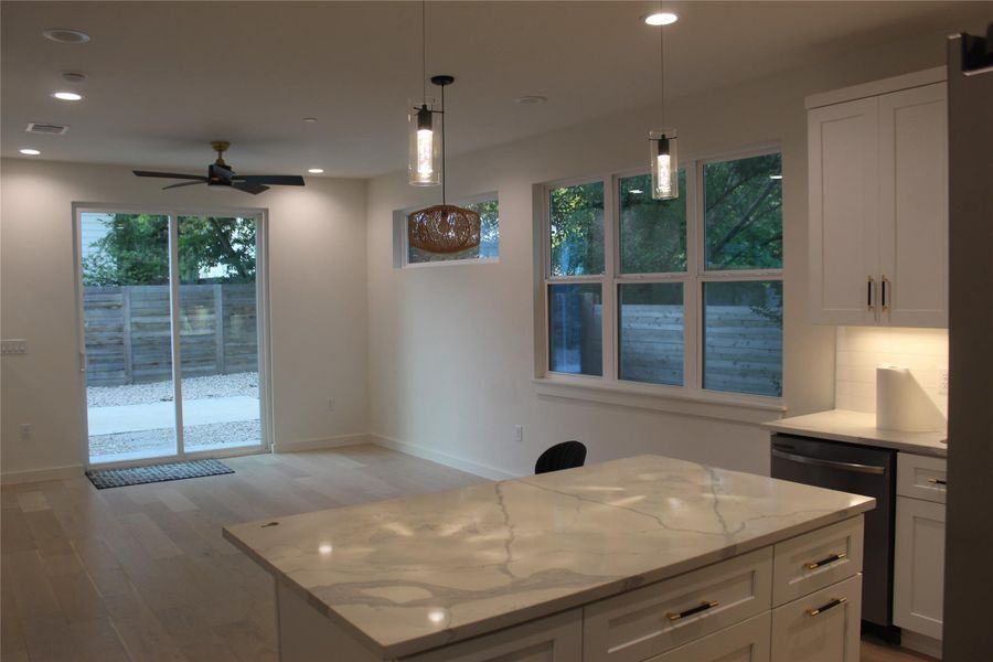 A well-lit space features recessed lighting and a striking kitchen island with ample counter space.