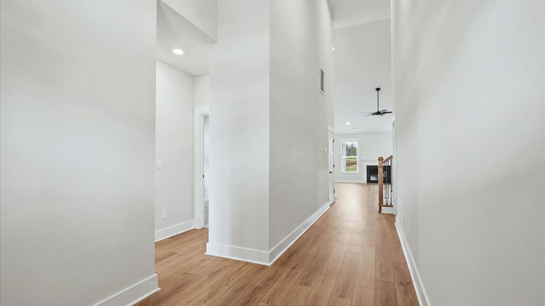 Superior design begins at the front door with a hardwood floor foyer and elegant sightlines at Fox Hollow