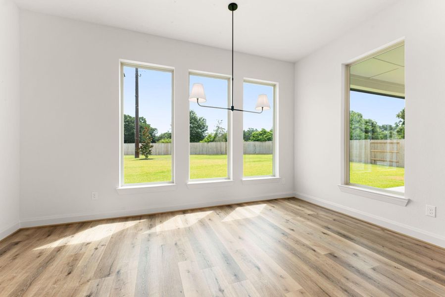 A sunlit breakfast nook framed by three oversized windows offers the perfect spot for a table for six, with backyard views built right in. A sunlit breakfast nook framed by three oversized windows offers the perfect spot for a table for six, with backyard views built right in.