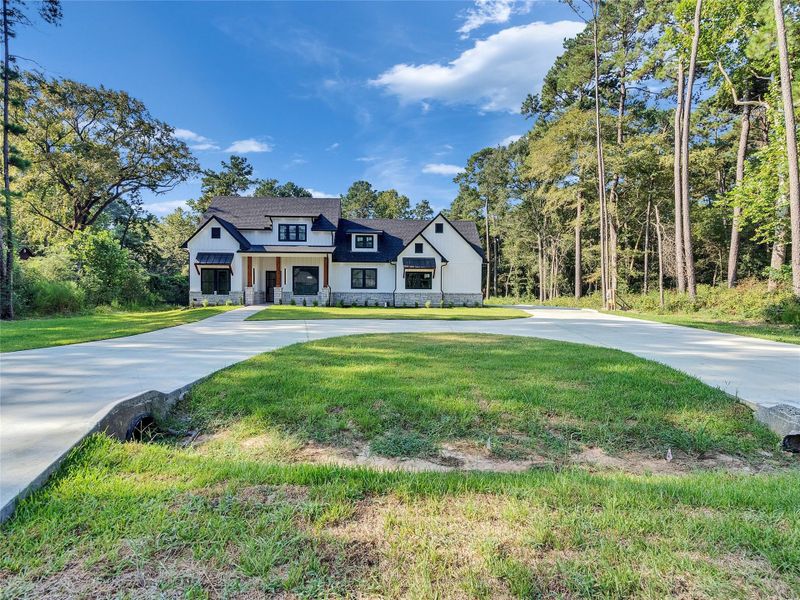 Front exterior of a new home in , Magnolia, TX, highlighting curb appeal (Image 2).