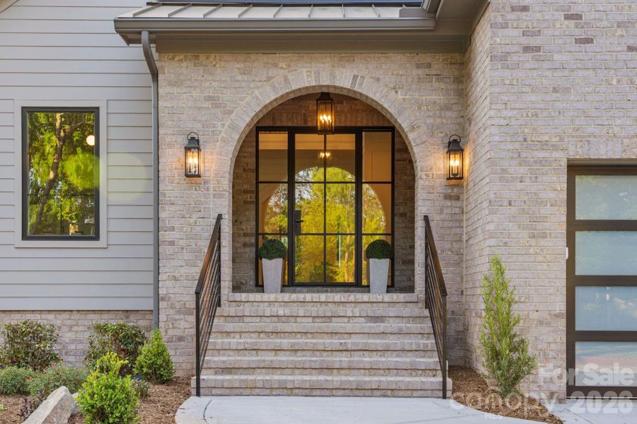 Inviting arched brick covered front entry