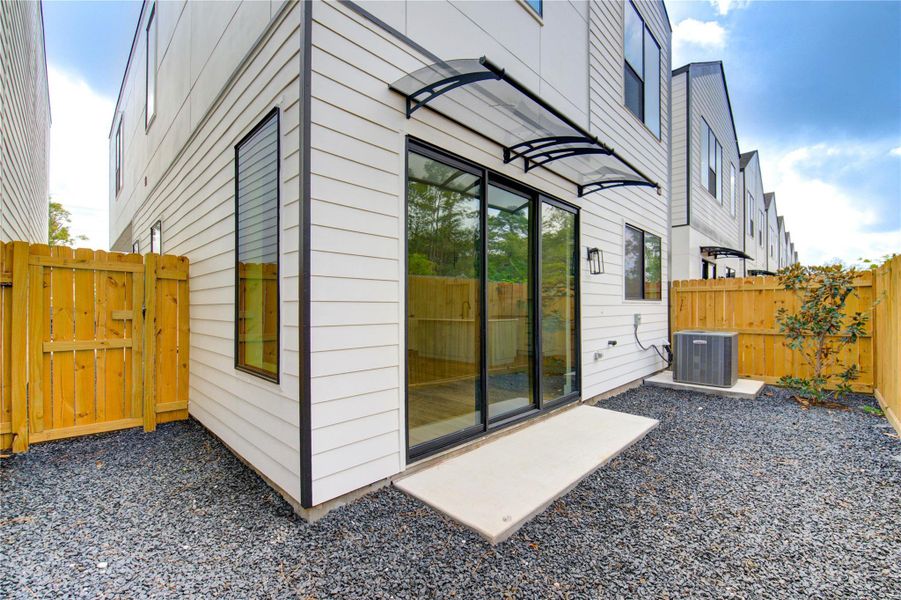 Charming fenced backyard with a stylish covered awning, perfect for outdoor relaxation. Charming fenced backyard with a stylish covered awning, perfect for outdoor relaxation.
