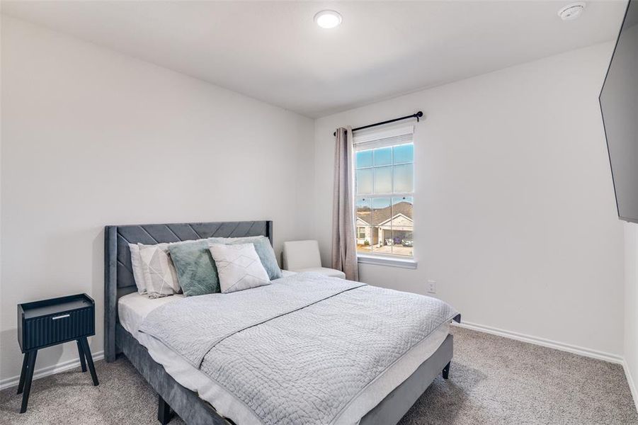 Bedroom with baseboards and light colored carpet Bedroom with baseboards and light colored carpet