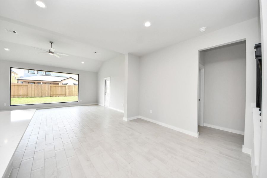 Welcome family and guests to your charming living room! With its high ceilings, recessed lighting, ceiling fan, custom paint, beautiful flooring, and large windows that let in abundant natural light, this room is perfect for gatherings. Welcome family and guests to your charming living room! With its high ceilings, recessed lighting, ceiling fan, custom paint, beautiful flooring, and large windows that let in abundant natural light, this room is perfect for gatherings.