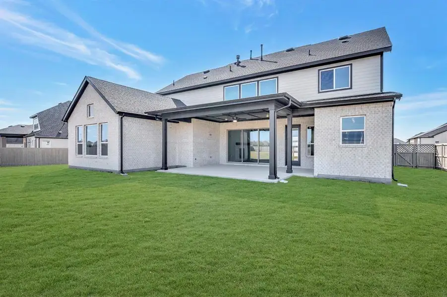 Back of house featuring a fenced backyard, a patio area, brick siding, and roof with shingles Back of house featuring a fenced backyard, a patio area, brick siding, and roof with shingles