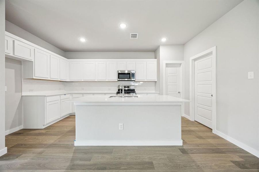 Kitchen in the Hayden home plan by Trophy Signature Homes – REPRESENTATIVE PHOTO