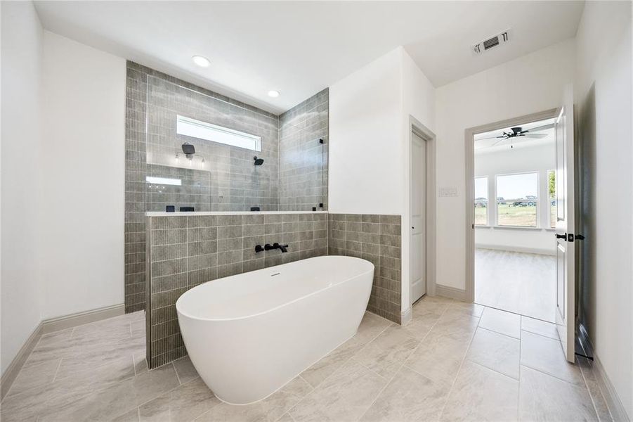 Bathroom featuring walk in shower, a soaking tub, recessed lighting, tile walls, and a ceiling fan