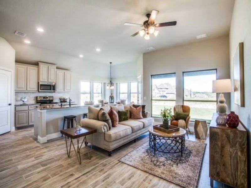 Living room featuring plenty of natural light, recessed lighting, light wood-style floors, and ceiling fan