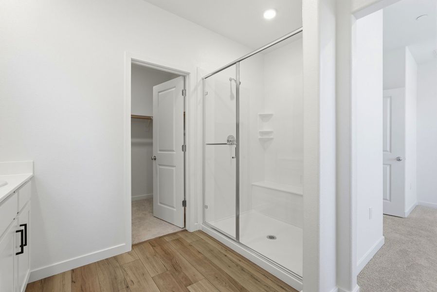 A bathroom with a glass shower. A bathroom with a glass shower.