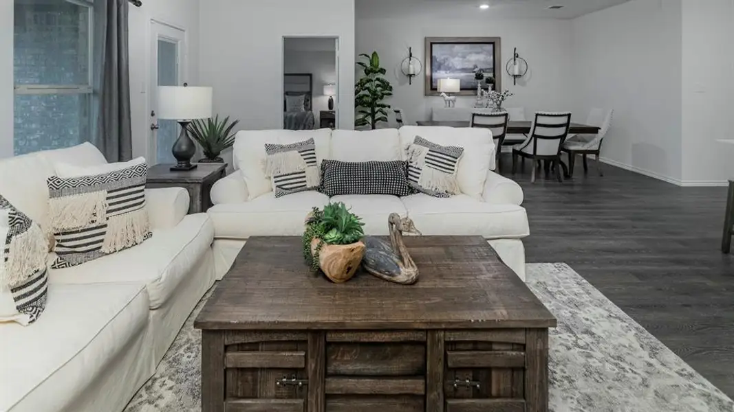 Spacious living area featuring wood-finish flooring, recessed lighting, and a neutral color palette