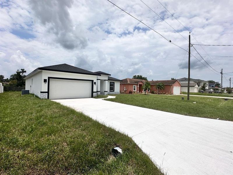 Front exterior of a new home in , Poinciana, FL, highlighting curb appeal (Image 17). Front exterior of a new home in , Poinciana, FL, highlighting curb appeal (Image 17).