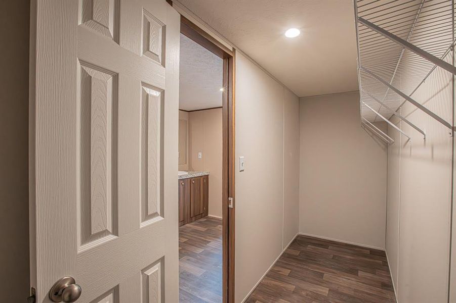 Walk in closet with dark wood-type flooring Walk in closet with dark wood-type flooring