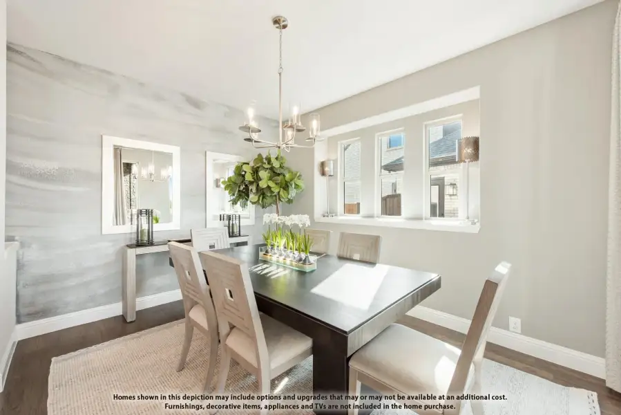 Dining room with dark wood table, light chairs, chandelier, and accent wall with gray wallpaper