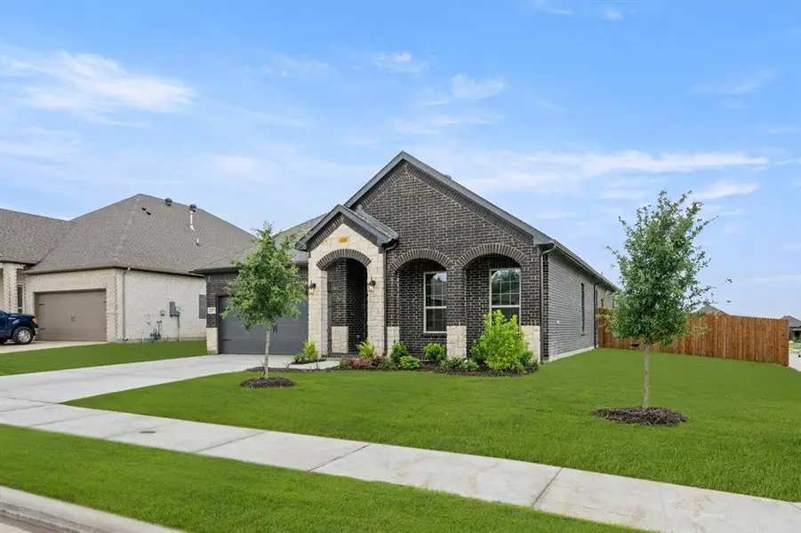 Front exterior of a new home in Sheppard's Place, Waxahachie, TX, highlighting curb appeal (Image 19). Front exterior of a new home in Sheppard's Place, Waxahachie, TX, highlighting curb appeal (Image 19).