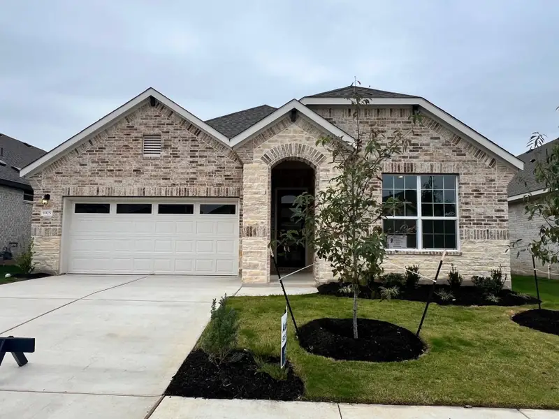 Front exterior of a new home in Rosenbusch Ranch, Leander, TX, highlighting curb appeal (Image 1).