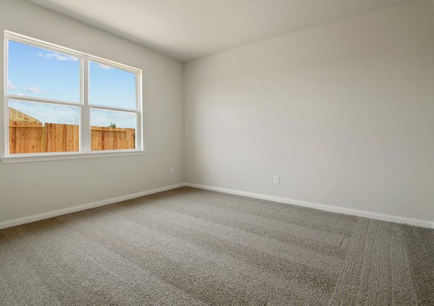 Master bedroom with a window facing the backyard