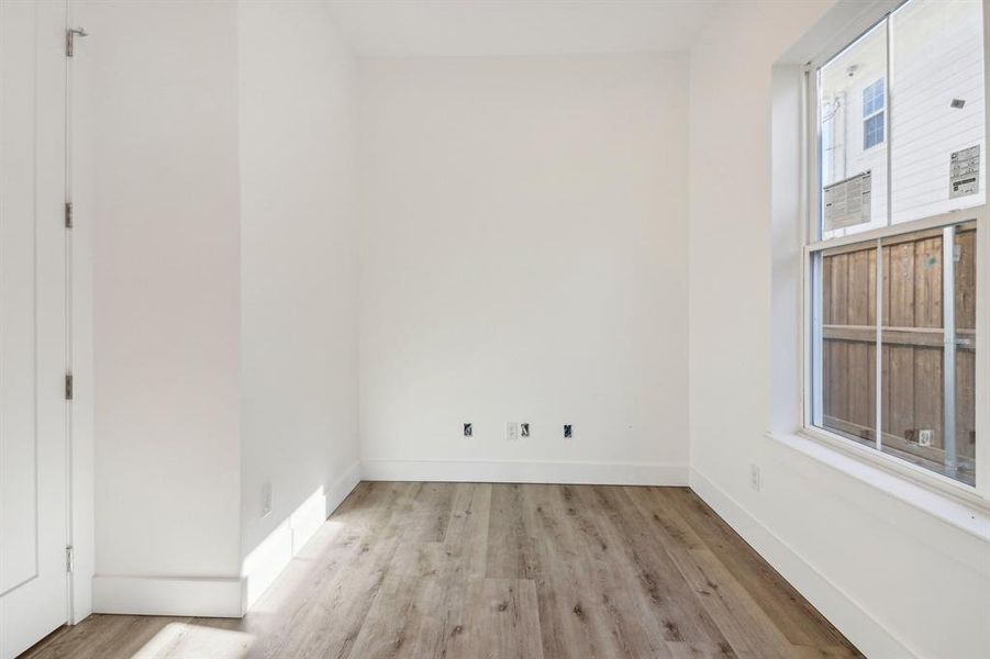 Empty room with light wood finished floors and baseboards