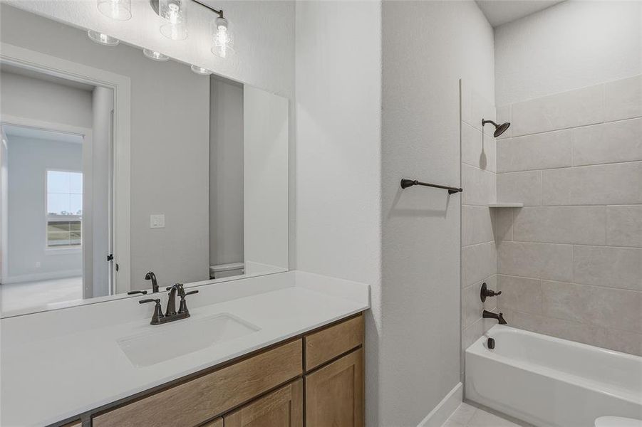 Bathroom featuring vanity and tub / shower combination