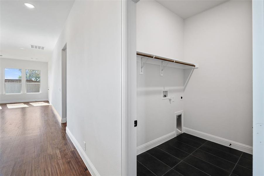 Washroom with hookup for a washing machine, hookup for an electric dryer, and recessed lighting