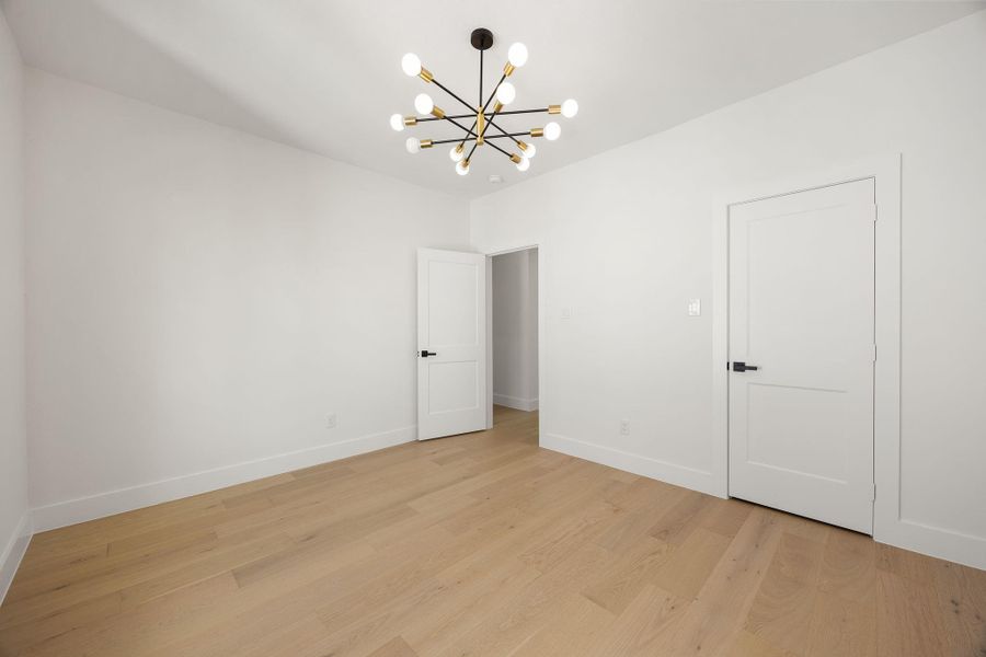 Third level bedroom with  spacious closet and a stylish designer light fixture.