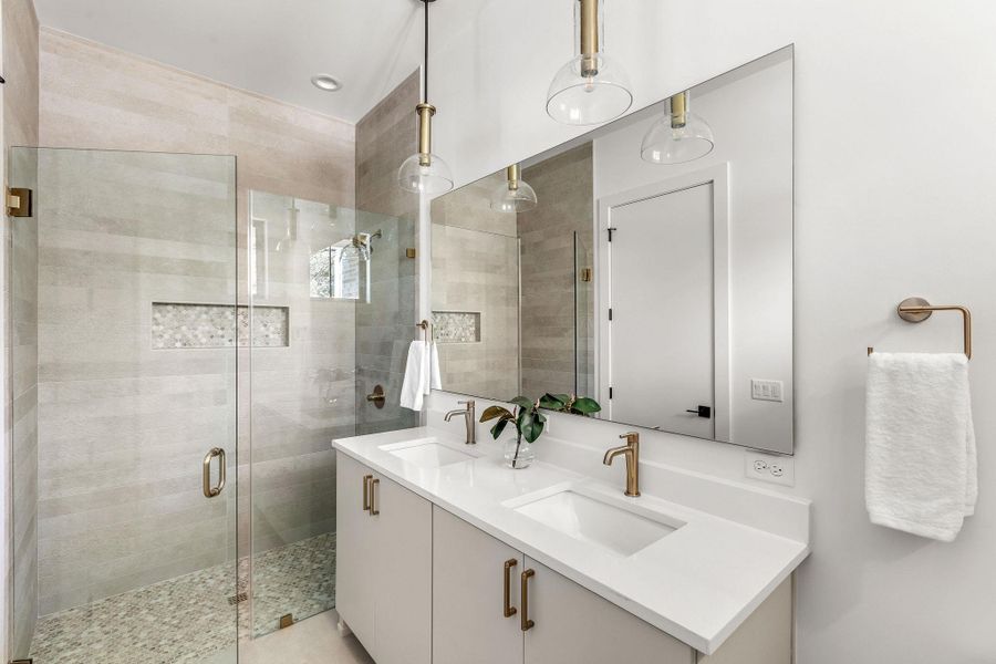 Full bathroom with a stall shower and double vanity