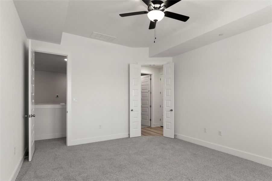 Unfurnished bedroom with carpet and ceiling fan