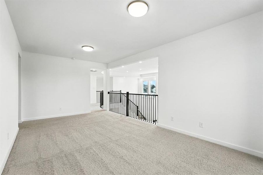 Empty room with carpet flooring and baseboards Empty room with carpet flooring and baseboards