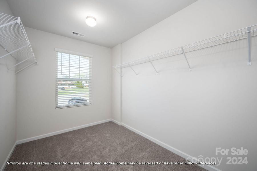 Primary bedroom walk-in closet