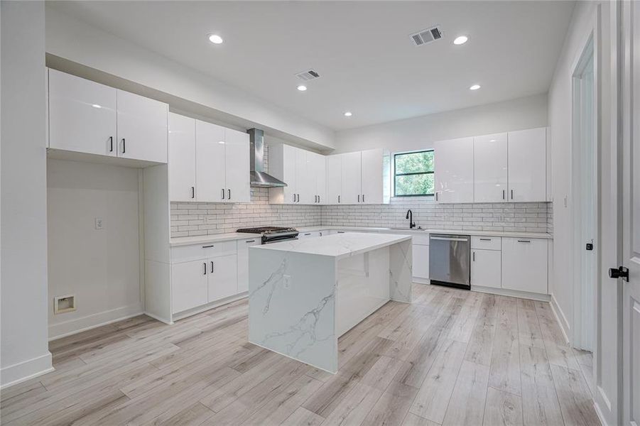 Large kitchen with lots of storage and a beautiful waterfall island