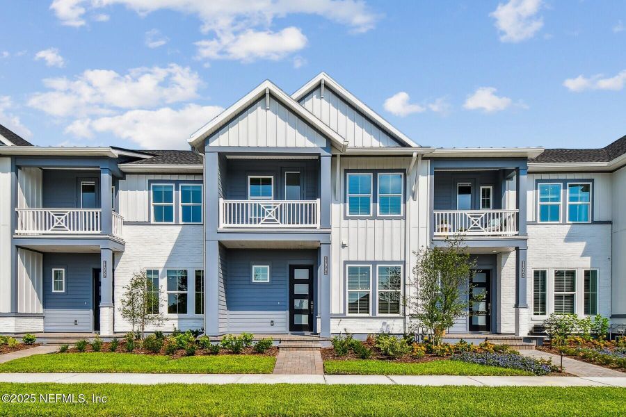 Front exterior of a new home in Seven Pines 24' Rear Entry Townhomes, Jacksonville, FL, highlighting curb appeal (Image 1).