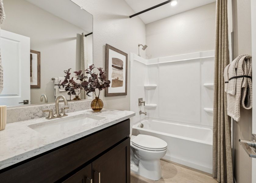 A bathroom with a sink toilet and bathtub.