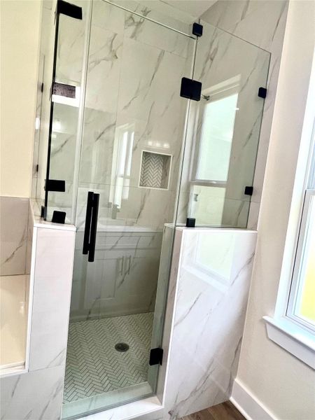 Elegant master bath with a sleek walk-in shower. Elegant master bath with a sleek walk-in shower.