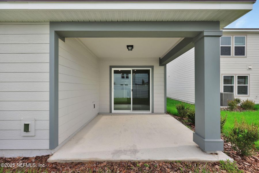 Front exterior of a new home in Wells Landing, Jacksonville, FL, highlighting curb appeal (Image 2).