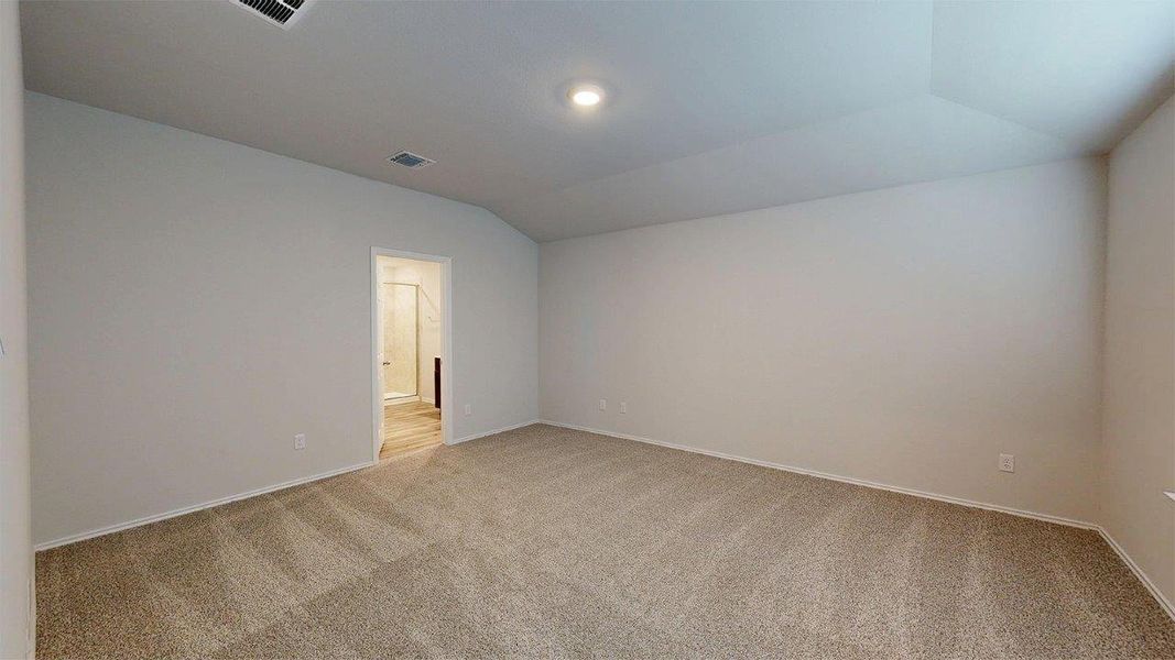 Spacious room featuring neutral carpeting, light-toned walls, and a recessed ceiling light Spacious room featuring neutral carpeting, light-toned walls, and a recessed ceiling light