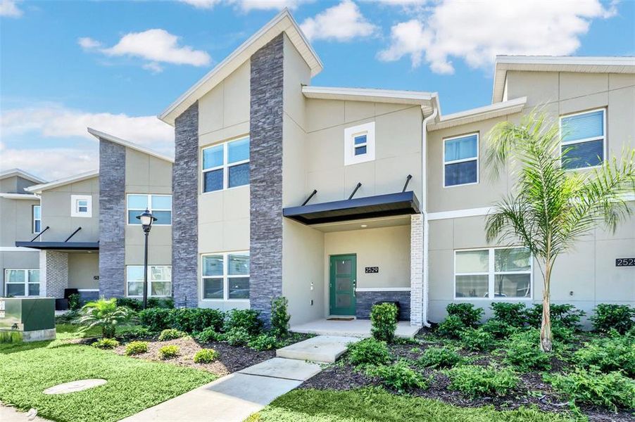 Front exterior of a new home in , Kissimmee, FL, highlighting curb appeal (Image 1).