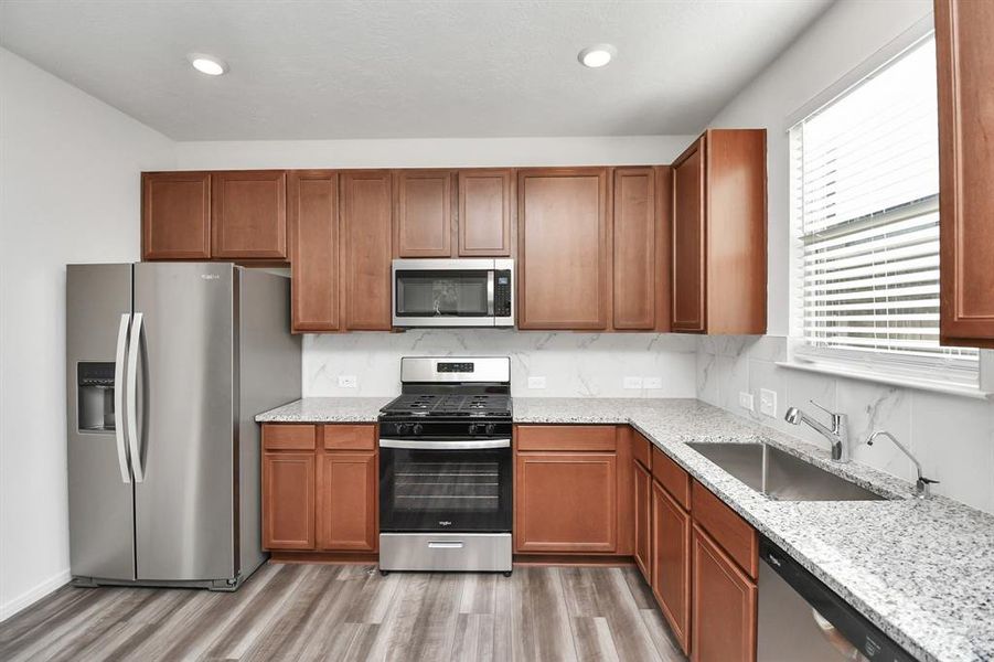 Stylish Island kitchen boasts granite counters,farm sink,stainless appliances, 42”cabinets,large walk-in pantry and open living concept. Refrigerator Included!