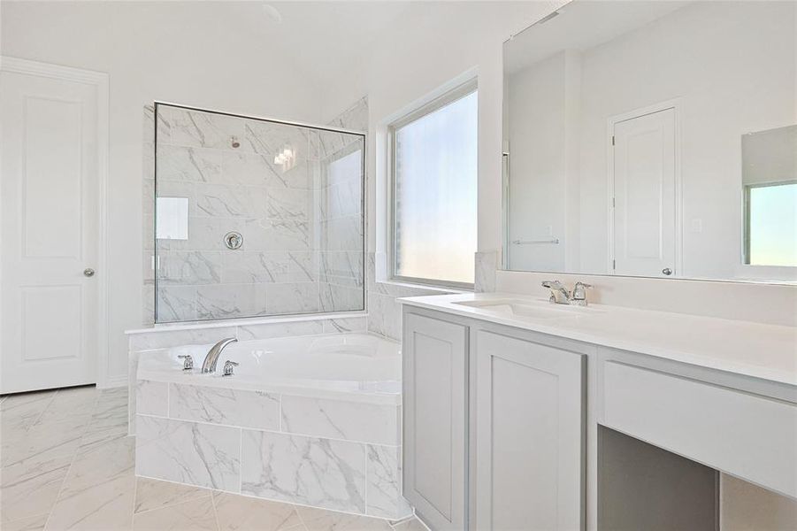 Bathroom with vanity, plus walk in shower, and vaulted ceiling