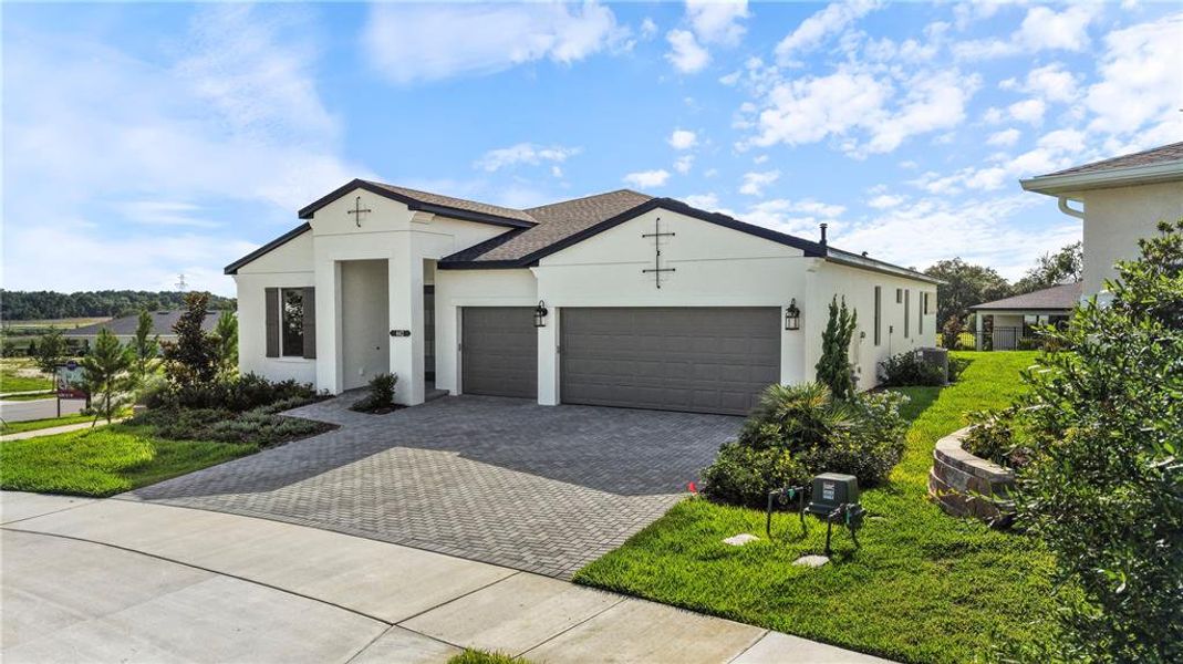 Front exterior of a new home in Cresswind at Hammock Oaks, Lady Lake, FL, highlighting curb appeal (Image 2). Front exterior of a new home in Cresswind at Hammock Oaks, Lady Lake, FL, highlighting curb appeal (Image 2).