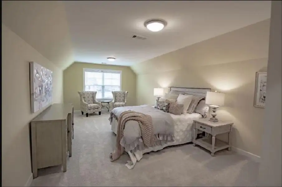 Carpeted room featuring a double window, sloped ceilings, and two flush-mount ceiling lights