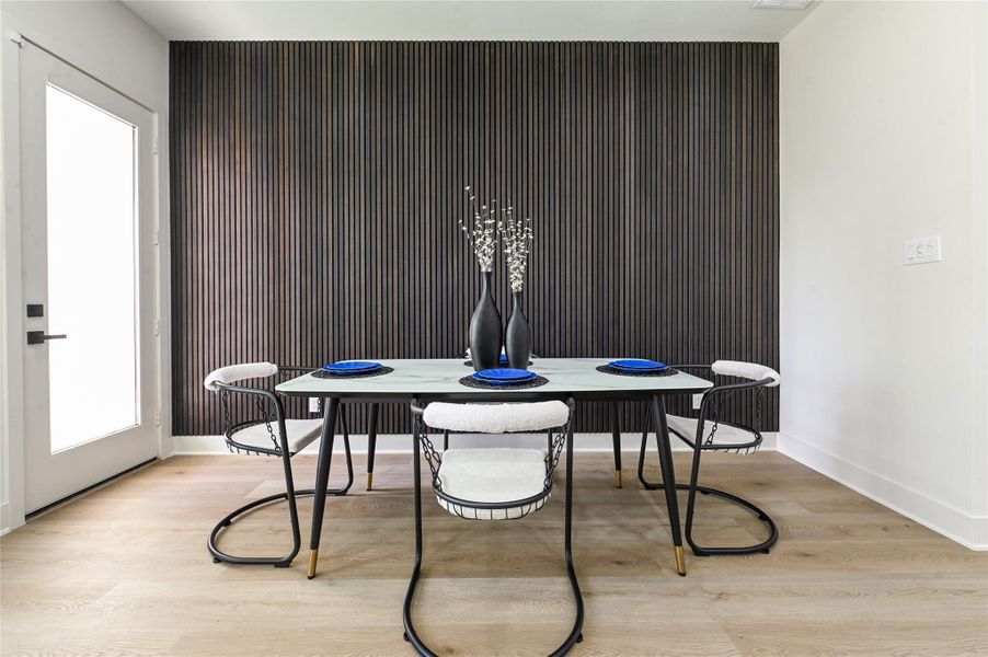 Acoustic paneled wall in dining room adds a touch of elegance to this room