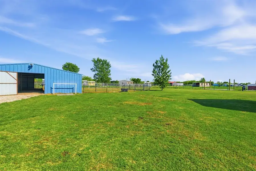 View of yard with a pole building, an outbuilding, and a garage View of yard with a pole building, an outbuilding, and a garage