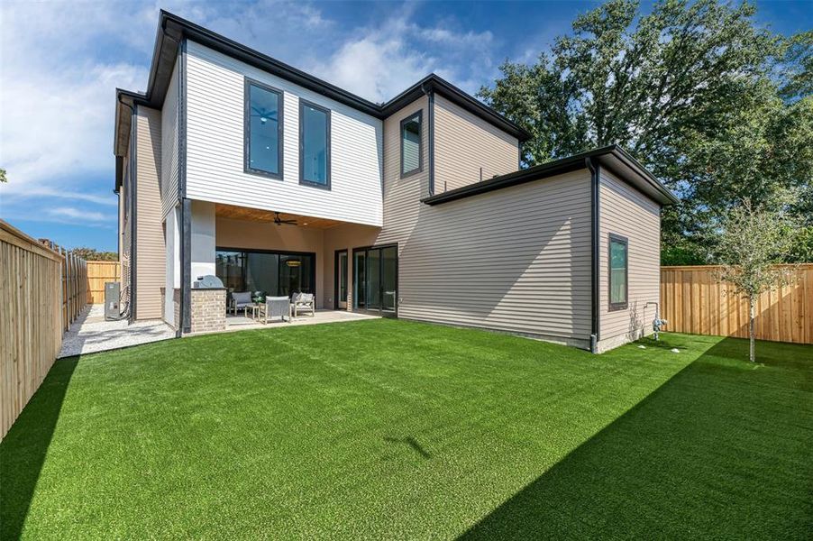 Back of house featuring a fenced backyard, ceiling fan, and a patio Back of house featuring a fenced backyard, ceiling fan, and a patio