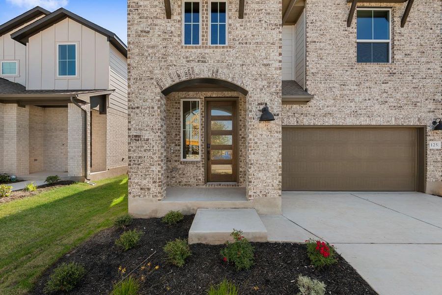 Front exterior of a new home in Terrace Collection at Lariat, Liberty Hill, TX, highlighting curb appeal (Image 20). Front exterior of a new home in Terrace Collection at Lariat, Liberty Hill, TX, highlighting curb appeal (Image 20).