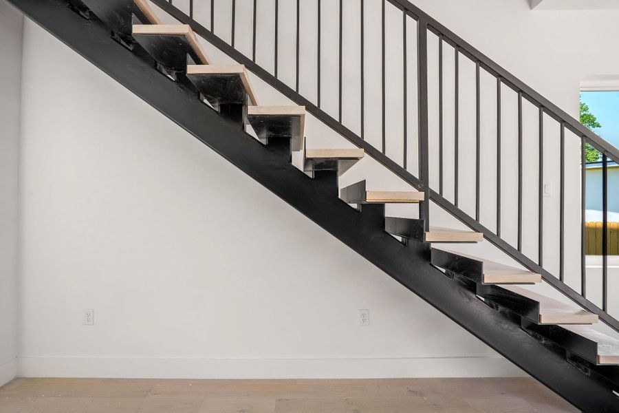 Stairs with baseboards and wood finished floors