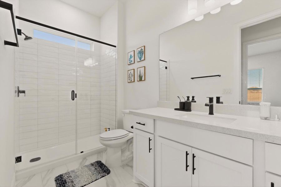 Bathroom featuring vanity and a shower stall